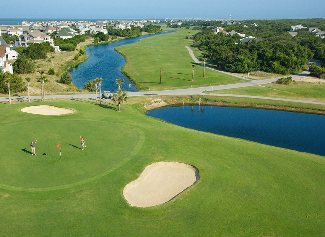 Industry by Insurance - Aerial View of a Coastal Golf Course With Ponds and Rivers on a Sunny Day