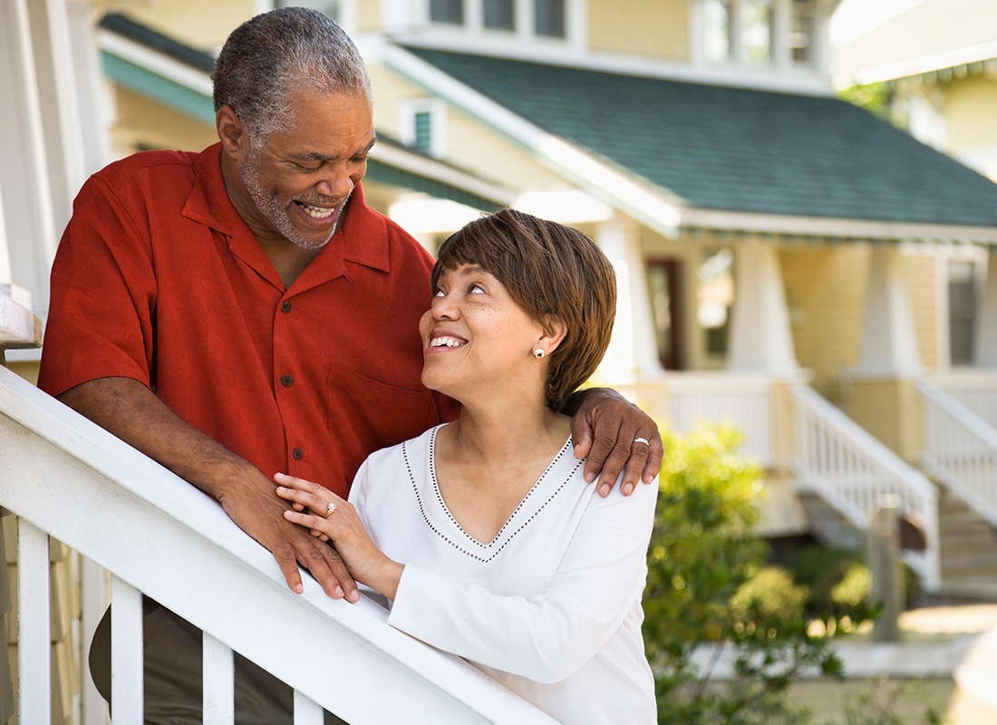 Medicare - Loving Older Couple Stands on Outdoor Stairs Looking at Each Other